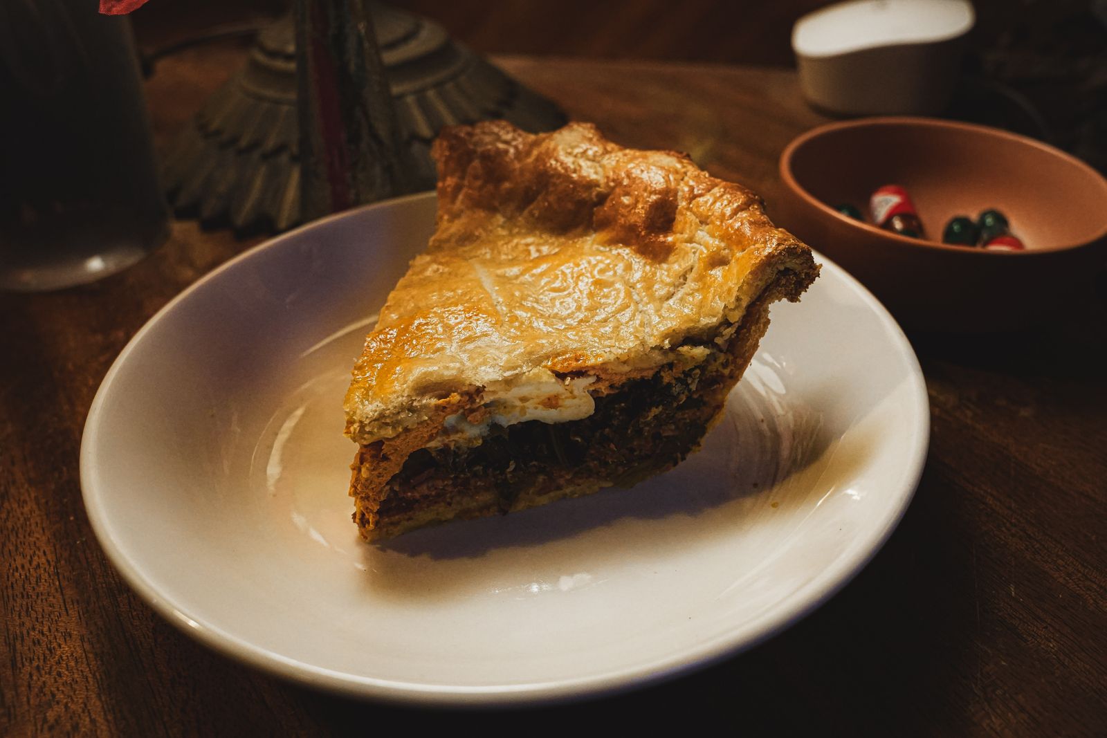 A slice of savory pie on a white plate